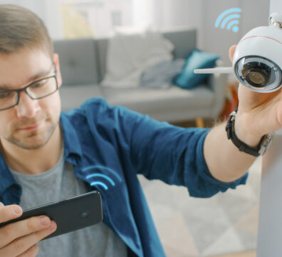 Man in blue shirt adjusting camera