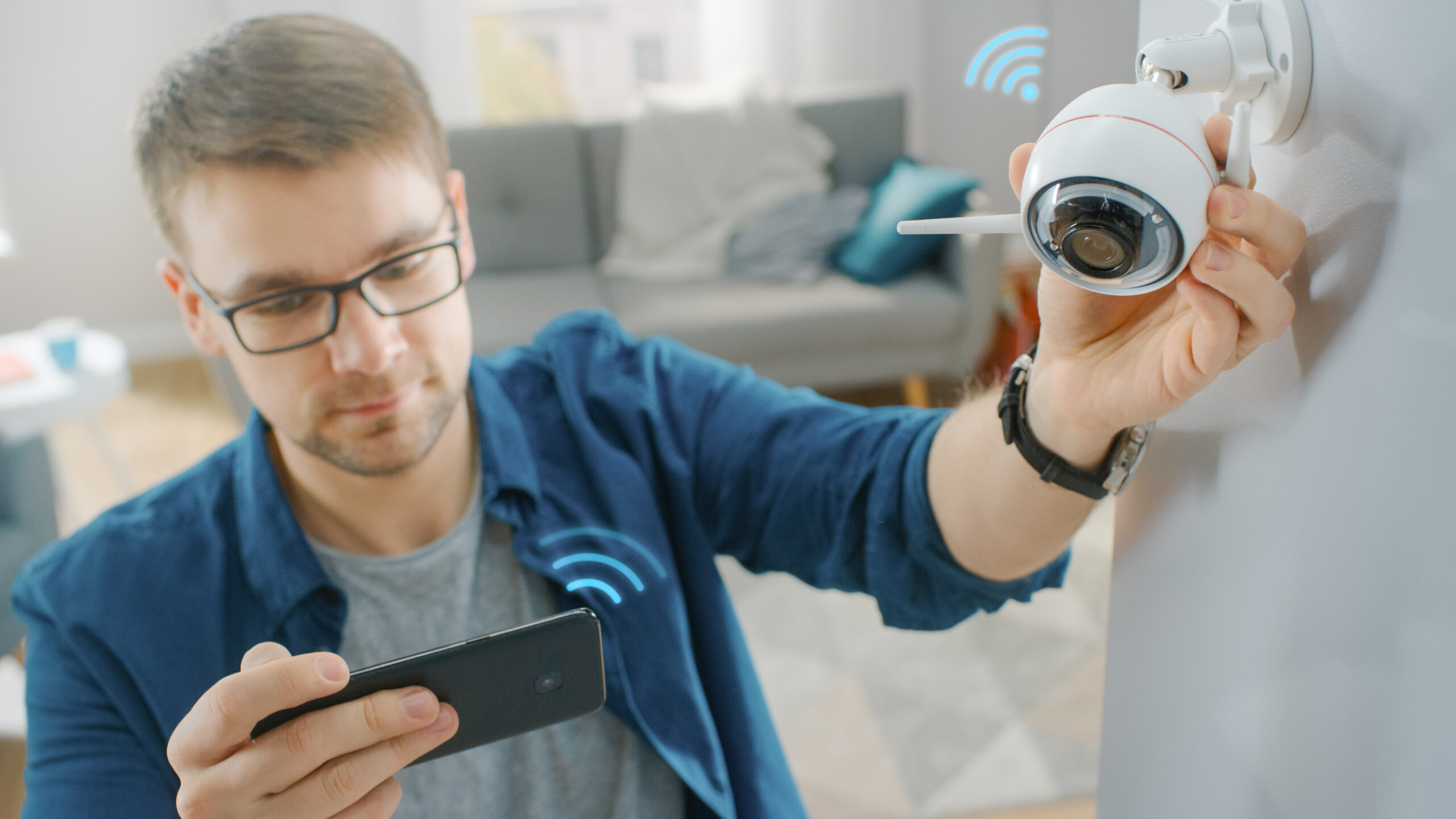 Man in blue shirt adjusting camera